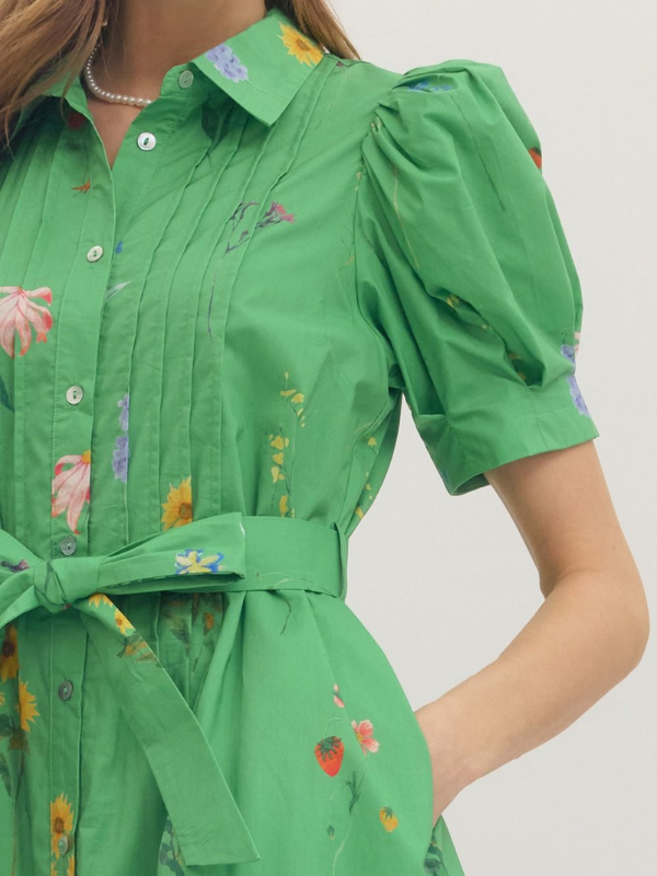 Green dress with floral patterns on a plain background