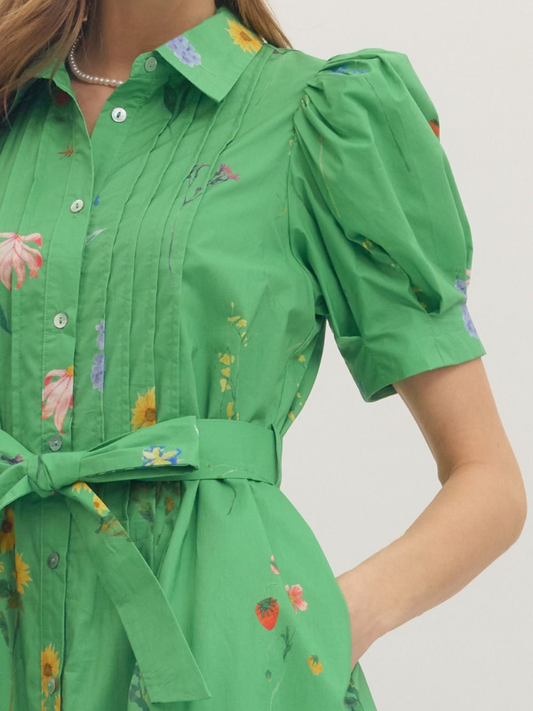 Green dress with floral patterns on a plain background