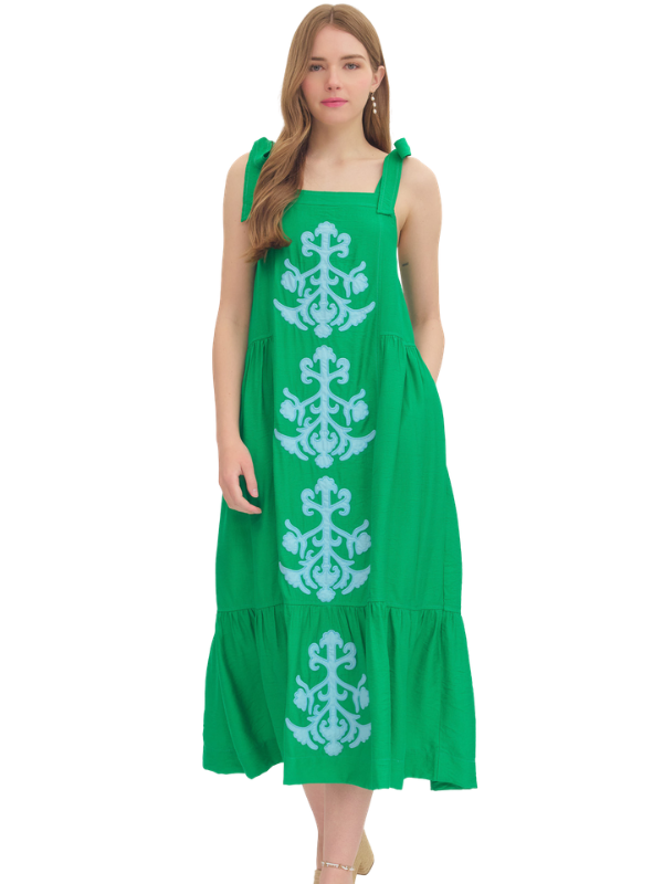 Green dress with white patterns on a white background