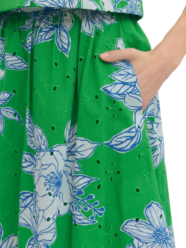 Green dress with white floral pattern on a white background