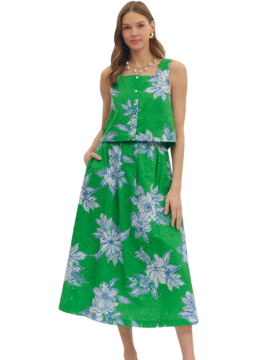 Woman wearing a green floral dress on a white background
