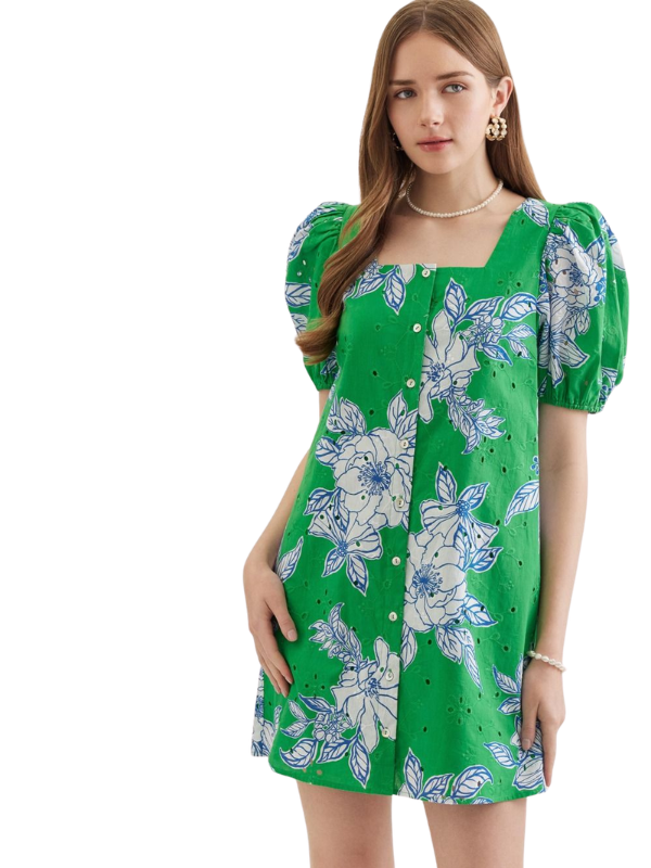 Woman wearing a green floral dress on a white background