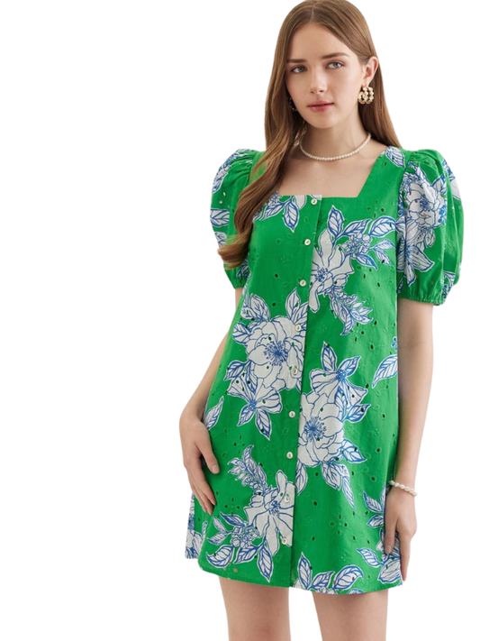 Woman wearing a green floral dress on a white background