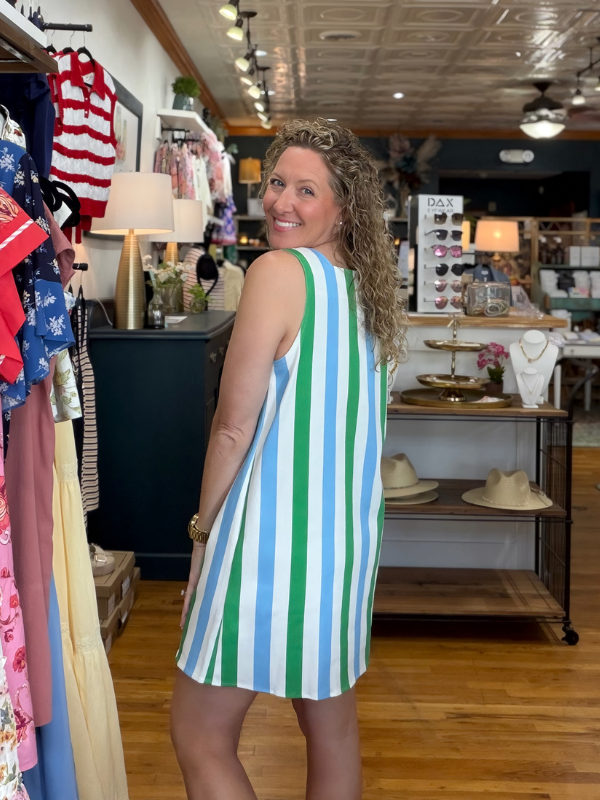 Woman wearing a striped dress in a store setting