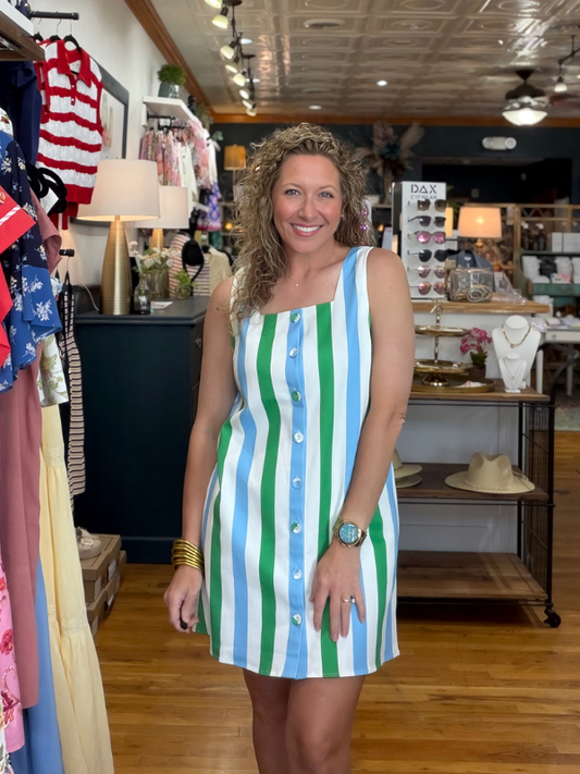 Woman wearing a striped dress in a store setting