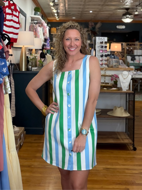 Woman wearing a striped dress in a store setting