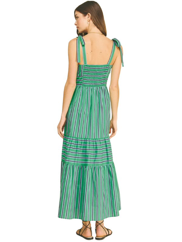 Woman wearing a green striped dress on a white background