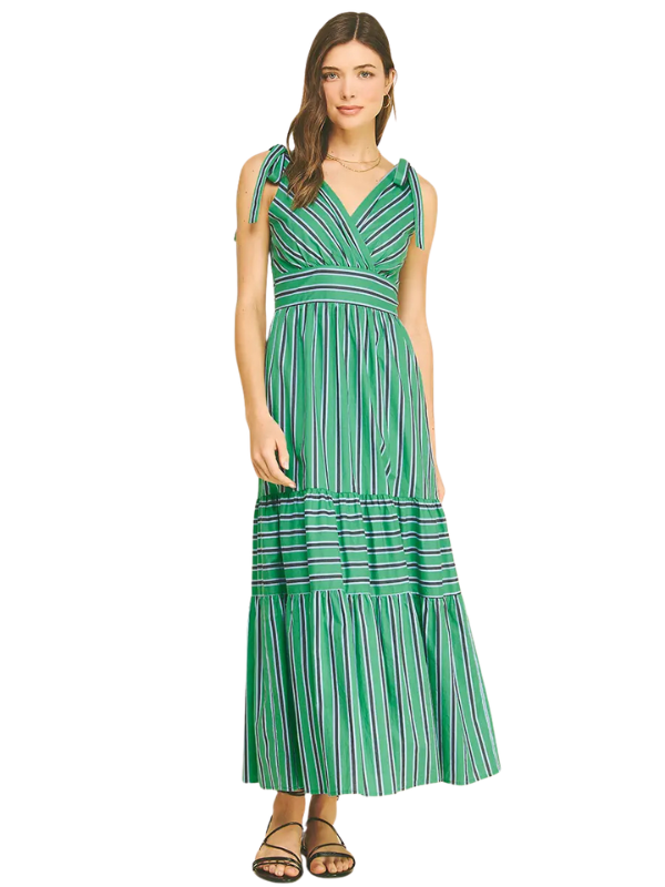Woman wearing a green and white striped dress on a white background