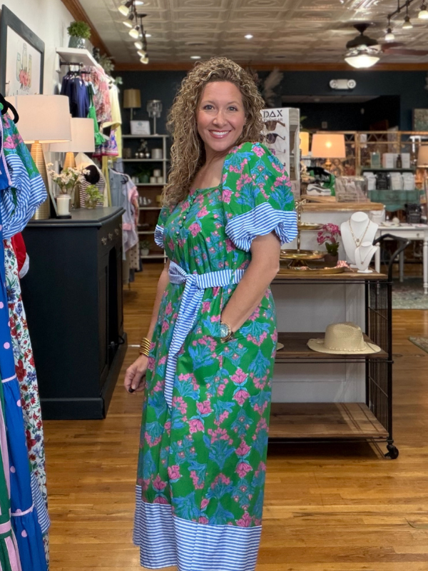 Woman wearing a floral dress in a store setting