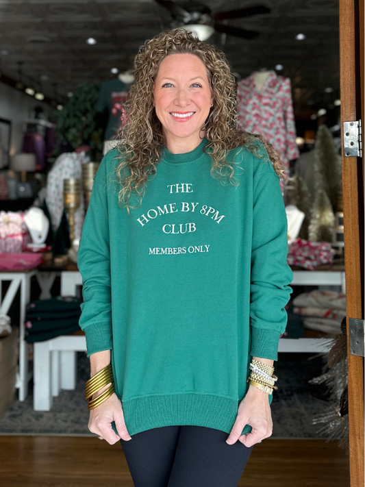 Woman wearing a green sweatshirt with text in a store setting