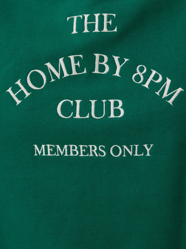 Green shirt with 'The Home by 8PM Club Members Only' text in white
