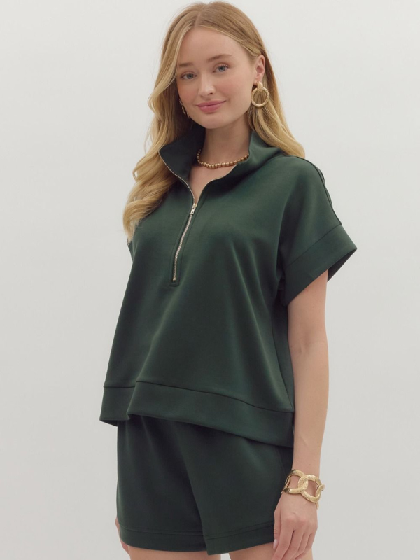 Woman wearing a green outfit with a white background