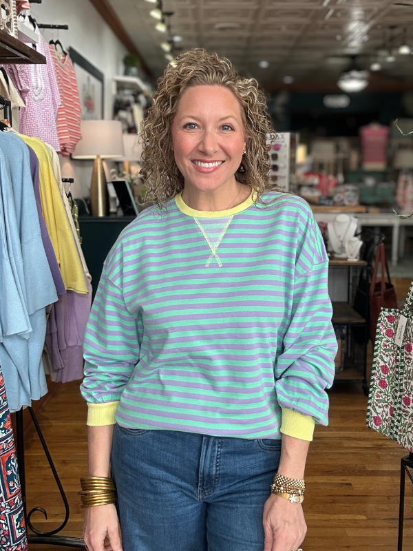 Woman wearing a striped shirt in a clothing store