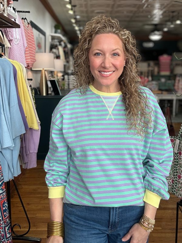 Woman wearing a striped shirt in a clothing store