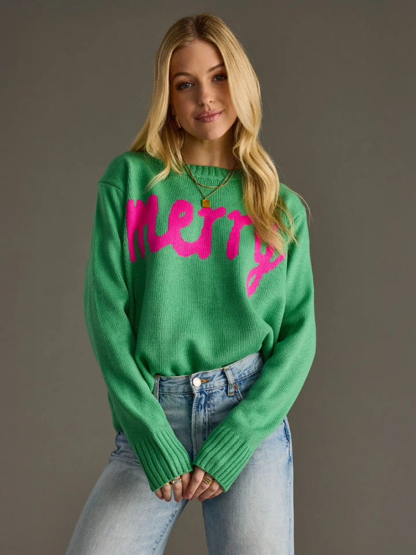 Woman wearing a green sweater with pink text against a gray background