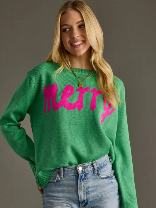 Woman wearing a green sweater with pink text on a gray background