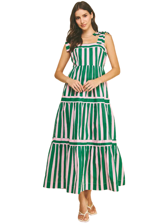 Woman wearing a green and white striped dress on a white background