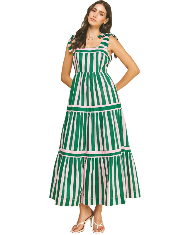 Woman wearing a green and white striped dress on a white background