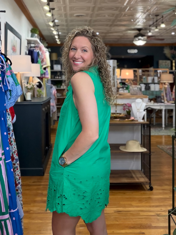 woman wearing a green dress in a store 