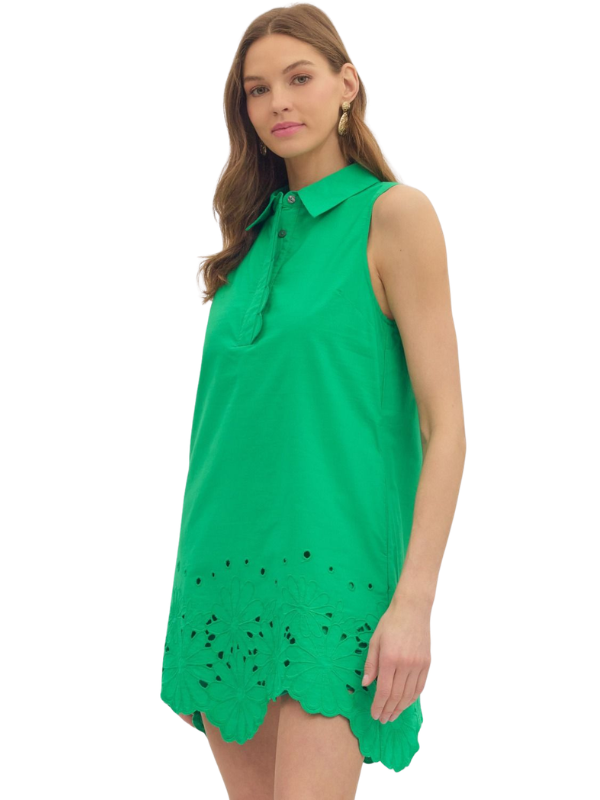 Woman wearing a green dress with lace details on a white background