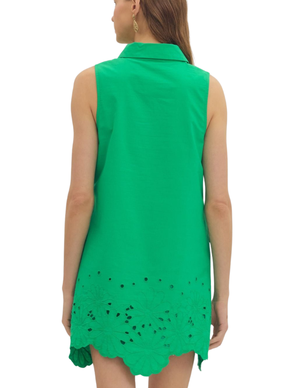 Green sleeveless dress with scalloped hem on a white background