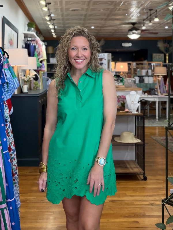 woman wearing a green dress in a store 