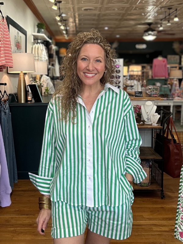 Woman wearing a green and white striped outfit in a store setting