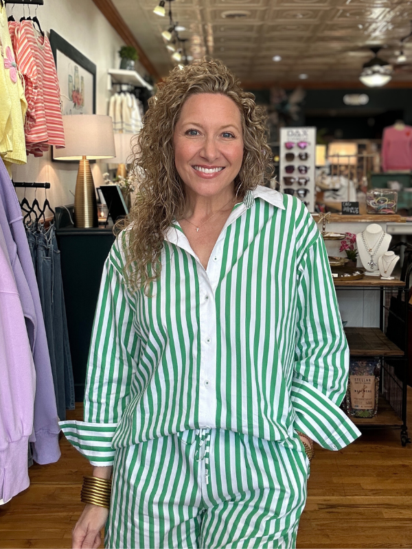 Woman wearing a green and white striped outfit in a store setting