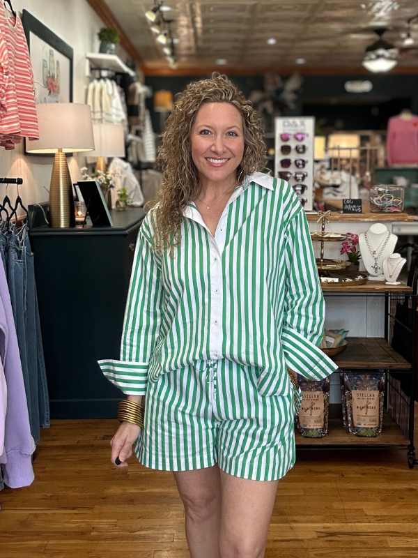 Woman wearing a green and white striped outfit in a store setting