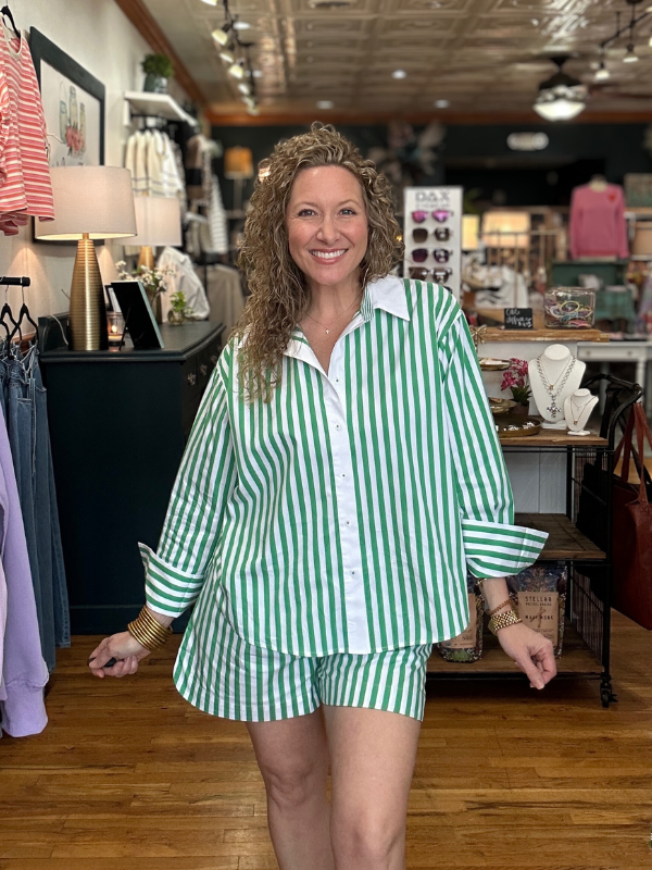 Woman wearing a green and white striped outfit in a store setting