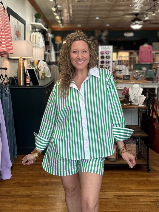 Woman wearing a green and white striped outfit in a store setting