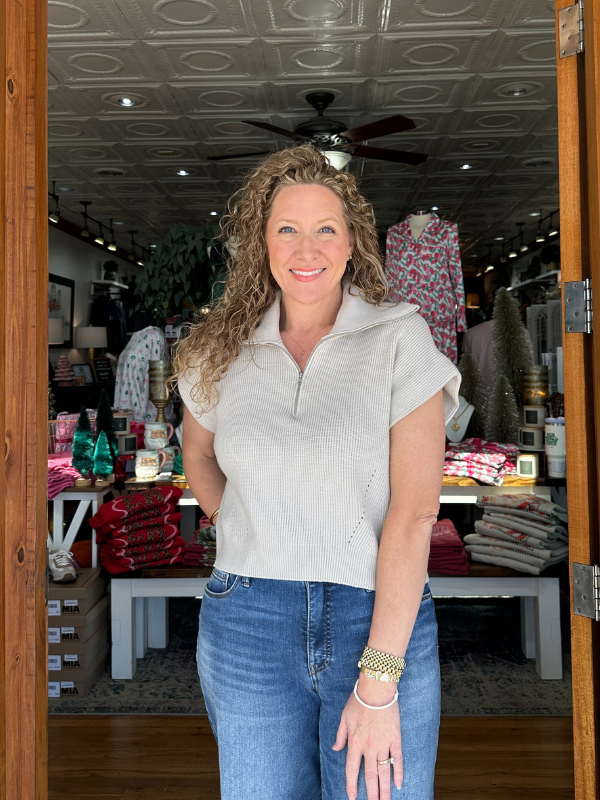Woman standing in a store with various items on display