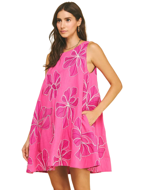 Woman wearing a pink floral dress on a white background