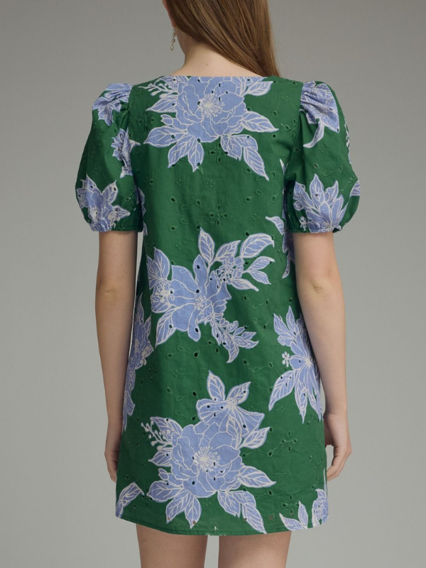 Green dress with blue floral patterns on a plain background