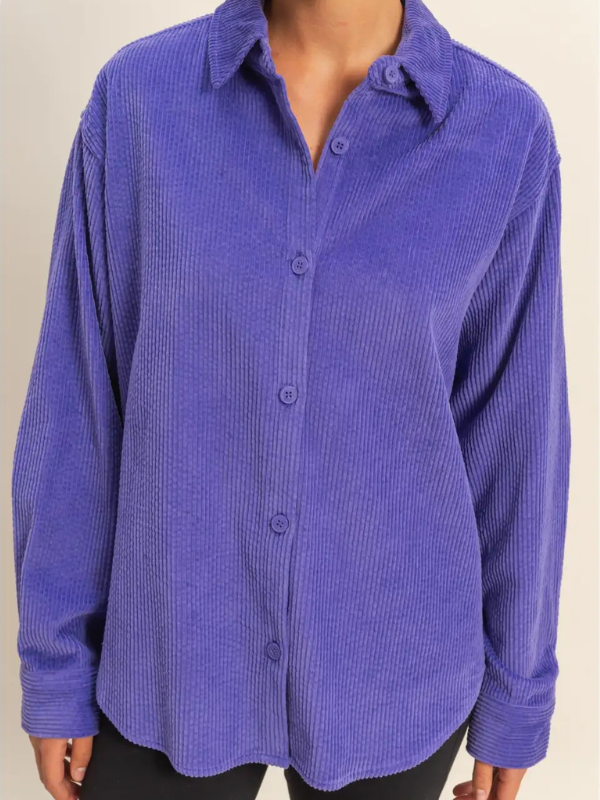 Purple textured shirt worn by a person on a plain background