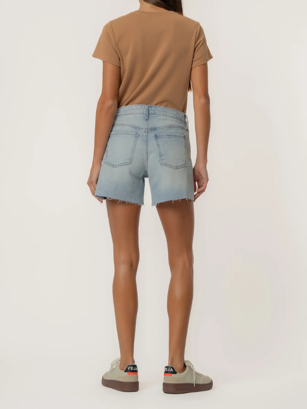 Person wearing light blue denim shorts and a brown t-shirt on a white background