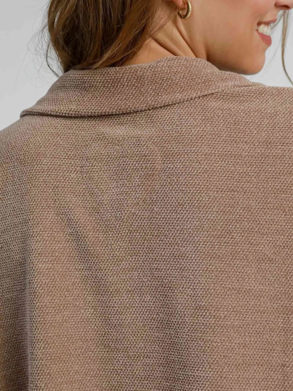 Close-up of a brown textured coat with a blurred background
