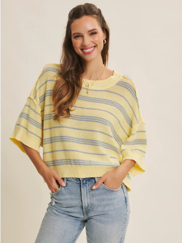 woman wearing yellow top with blue stripe