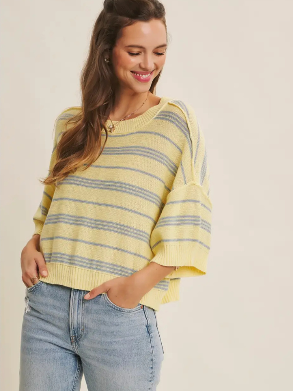 woman wearing yellow top with blue stripe