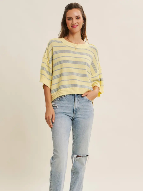 woman wearing yellow top with blue stripe