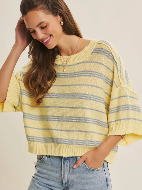 woman wearing yellow top with blue stripe
