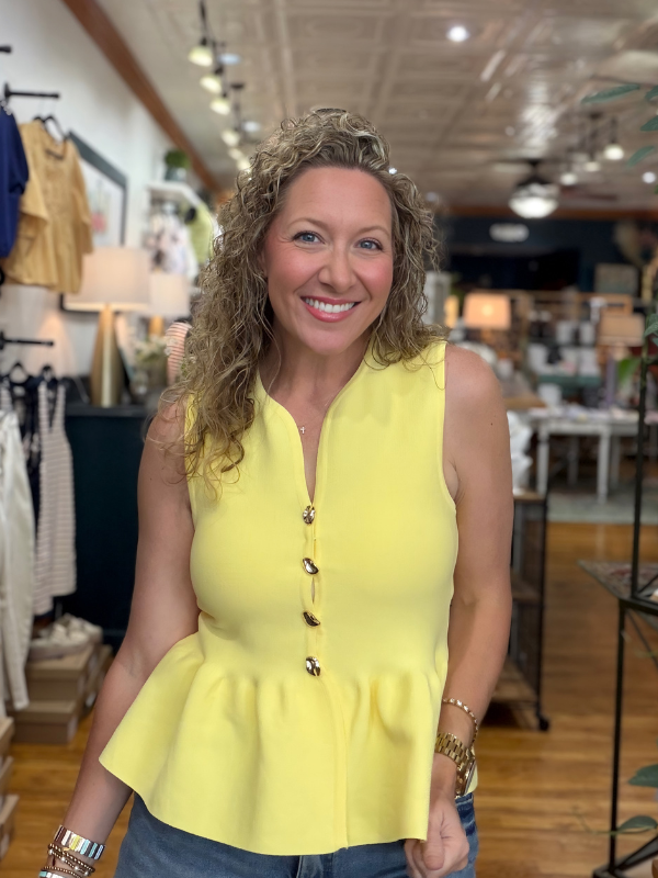 Woman wearing a yellow top in a store setting