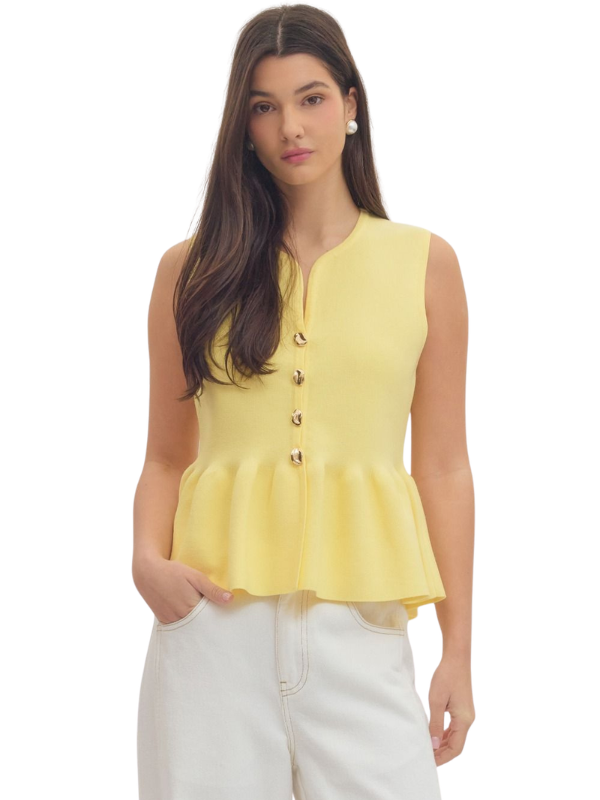 Woman wearing a yellow sleeveless top with buttons on a white background