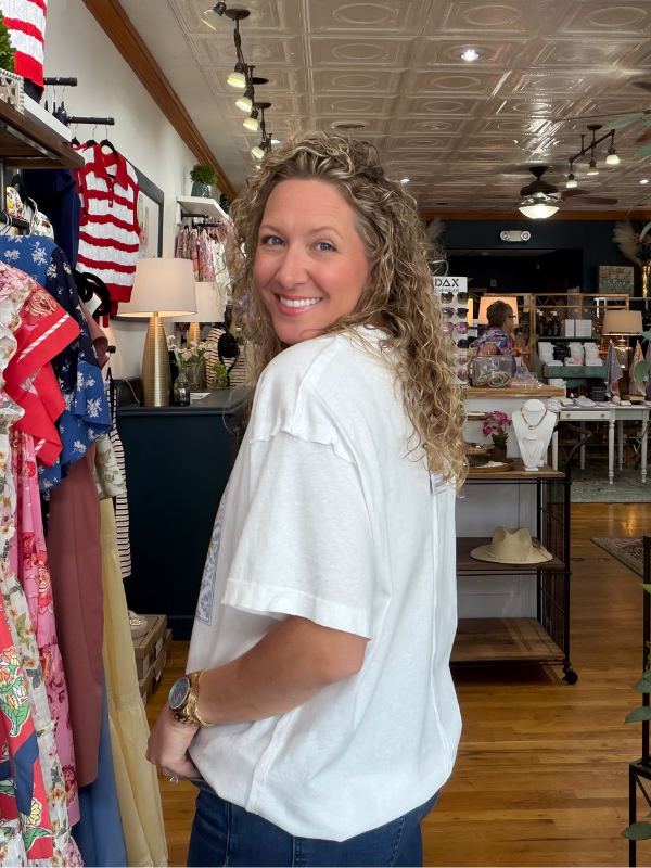 Woman wearing a white t-shirt with a lemon design in a store setting