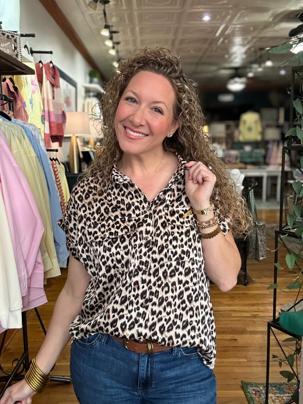 Woman wearing a leopard print shirt in a clothing store