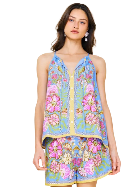 Woman wearing a colorful floral dress on a white background