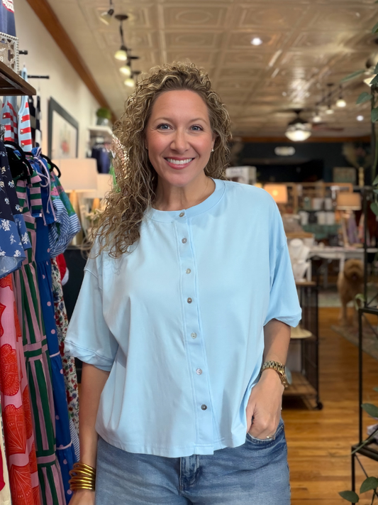Woman wearing a light blue shirt in a store setting