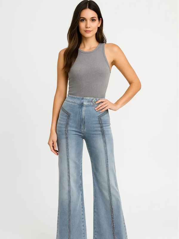 Woman wearing a gray tank top and light blue flared jeans on a white background