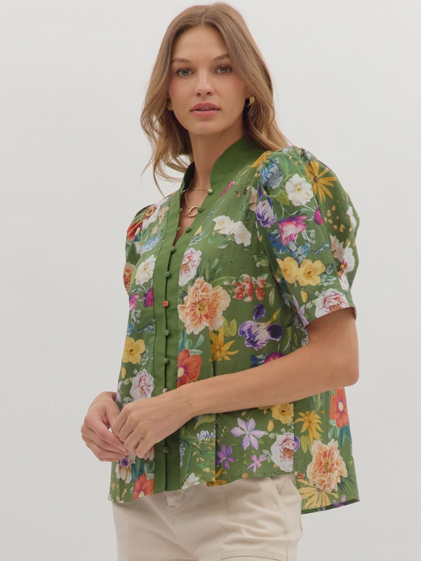 Woman wearing a green floral blouse on a white background