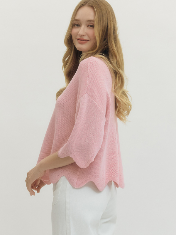 Woman wearing a pink blouse with a plain background